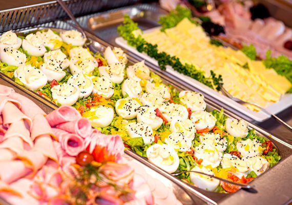 Swedish buffet at the party. Trays with cold snacks, cold cuts,